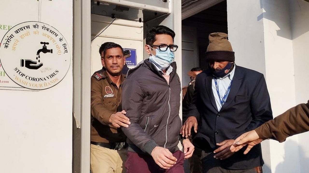 Delhi police takes away accused Shankar Mishra after producing him before the Patiala House Court in an Air India flight urinating case, in New Delhi. Credit: PTI Photo