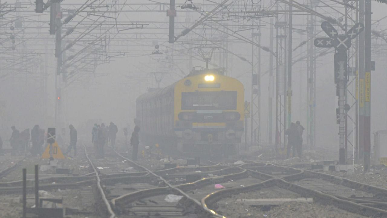  A train moves on its track amid dense fog during a cold winter morning, in Jalandhar. Credit: PTI 