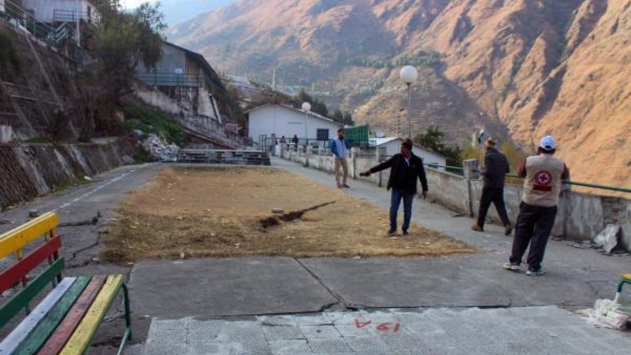 Cracks appear on the road due to landslides at Vishnupuram Marwari Colony, in Joshimath of Uttarakhand. Credit: PTI Photo