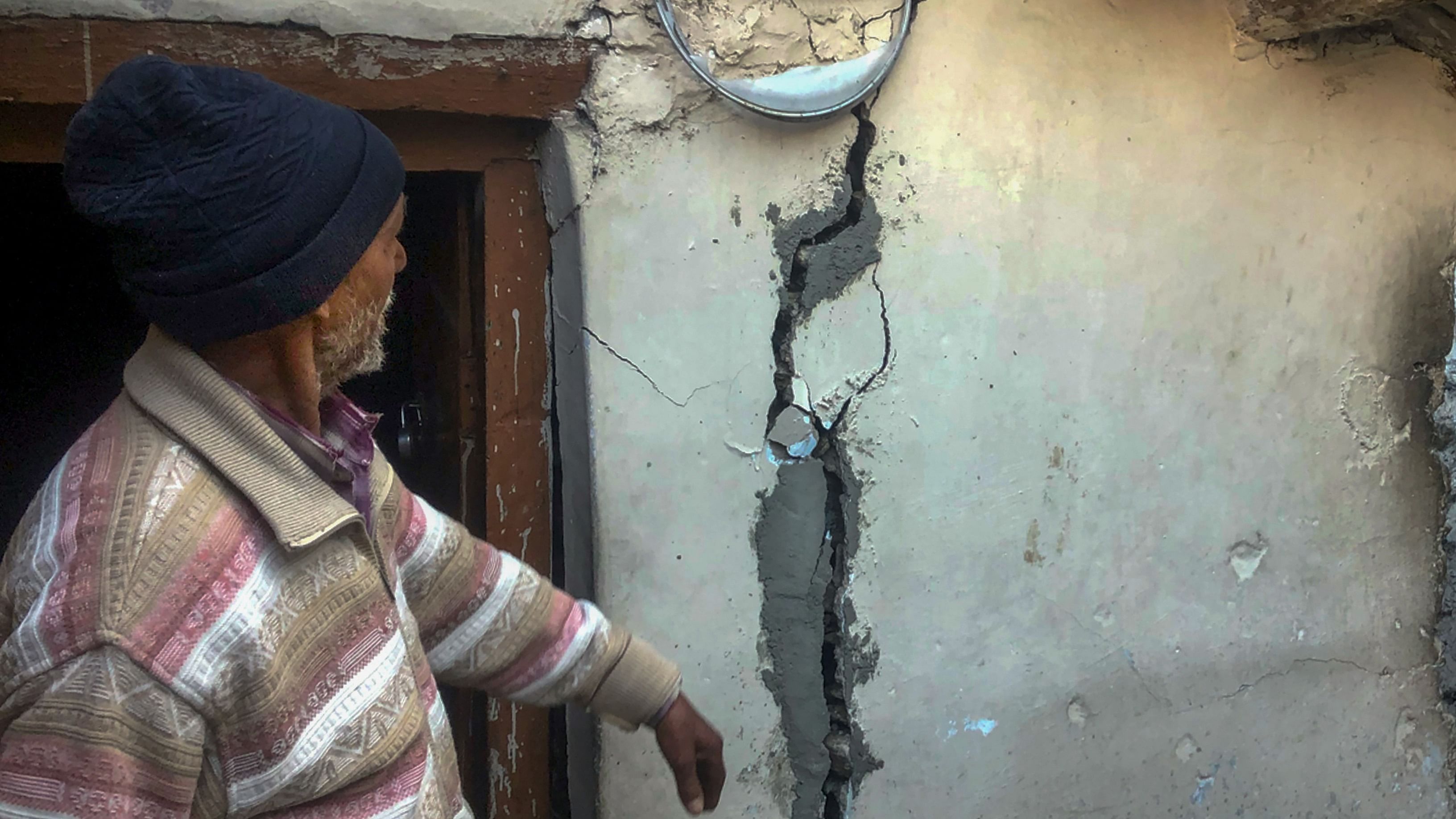 A man shows cracks appeared at his house at Joshimath in Chamoli district, Sunday, Jan. 8, 2023. Credit: PTI Photo