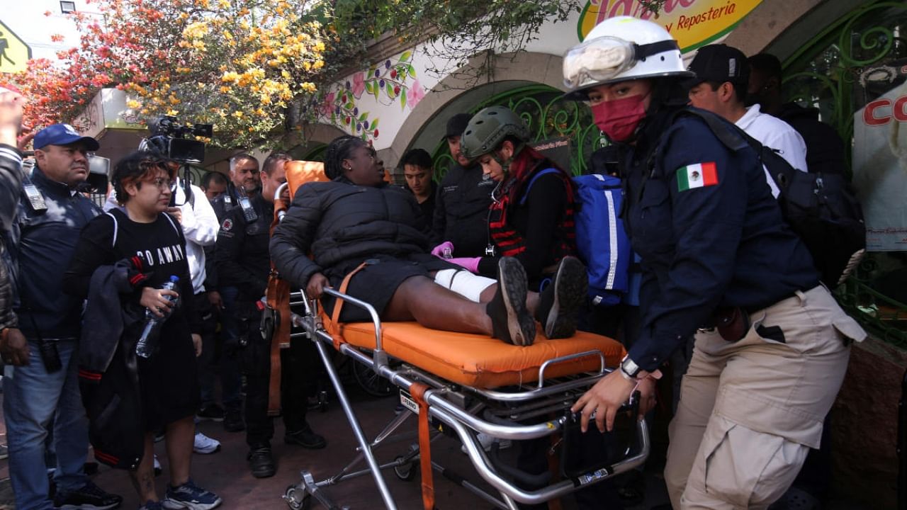 Paramedics assist a woman after two subway trains collide head-on at a subway station, in Mexico City. Credit: Reuters Photo