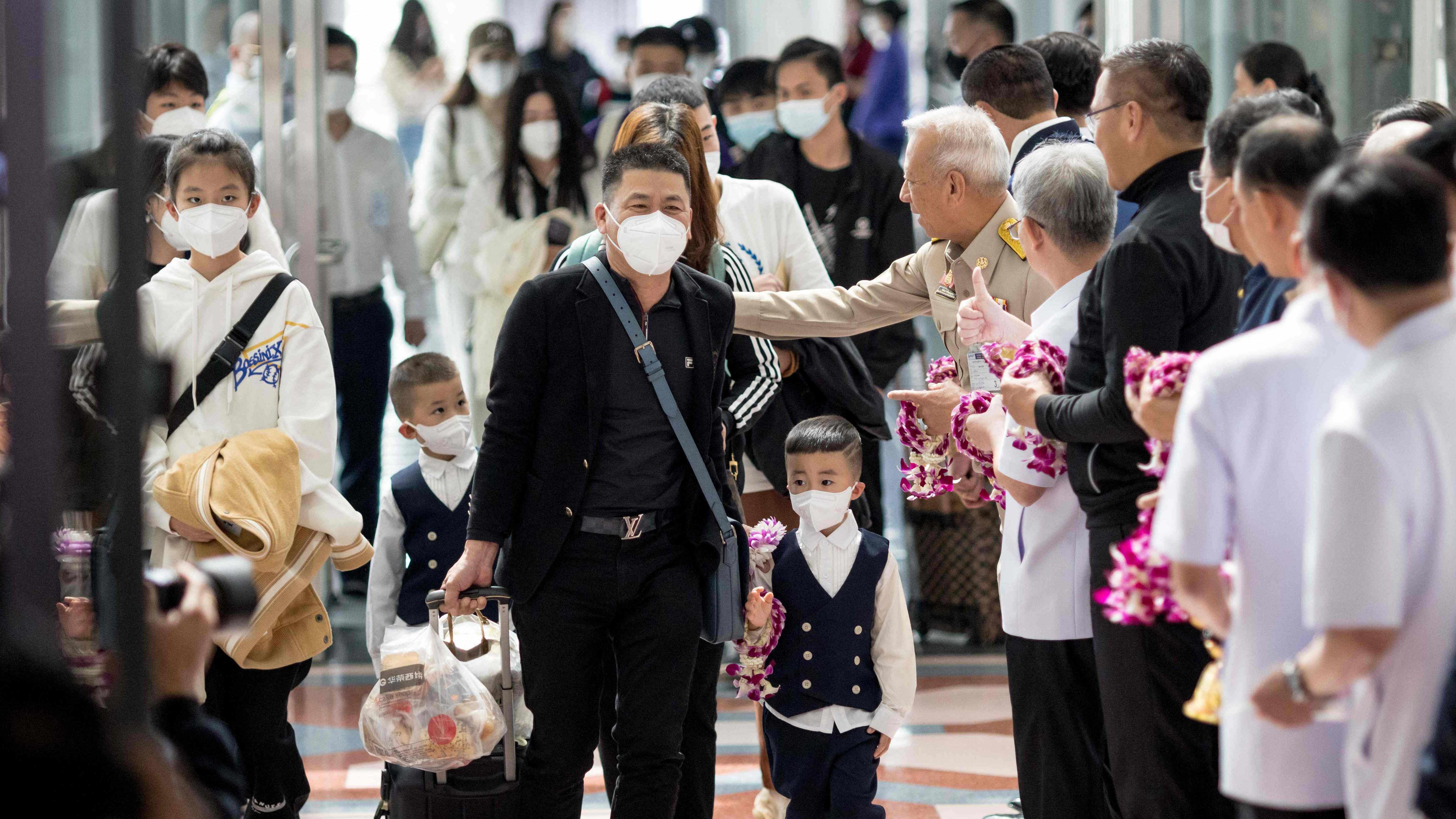 Travellers from a Xiamen Airlines flight are greeted by Thai health and government officials as they arrive at Suvarnabhumi Airport in Bangkok on January 9, 2023. Credit: AFP File Photo