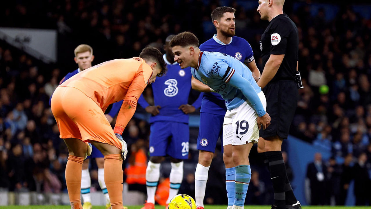 Manchester City's Julian Alvarez speaks to Chelsea's Kepa Arrizabalaga before scoring from the penalty spot. Credit: Reuters Photo