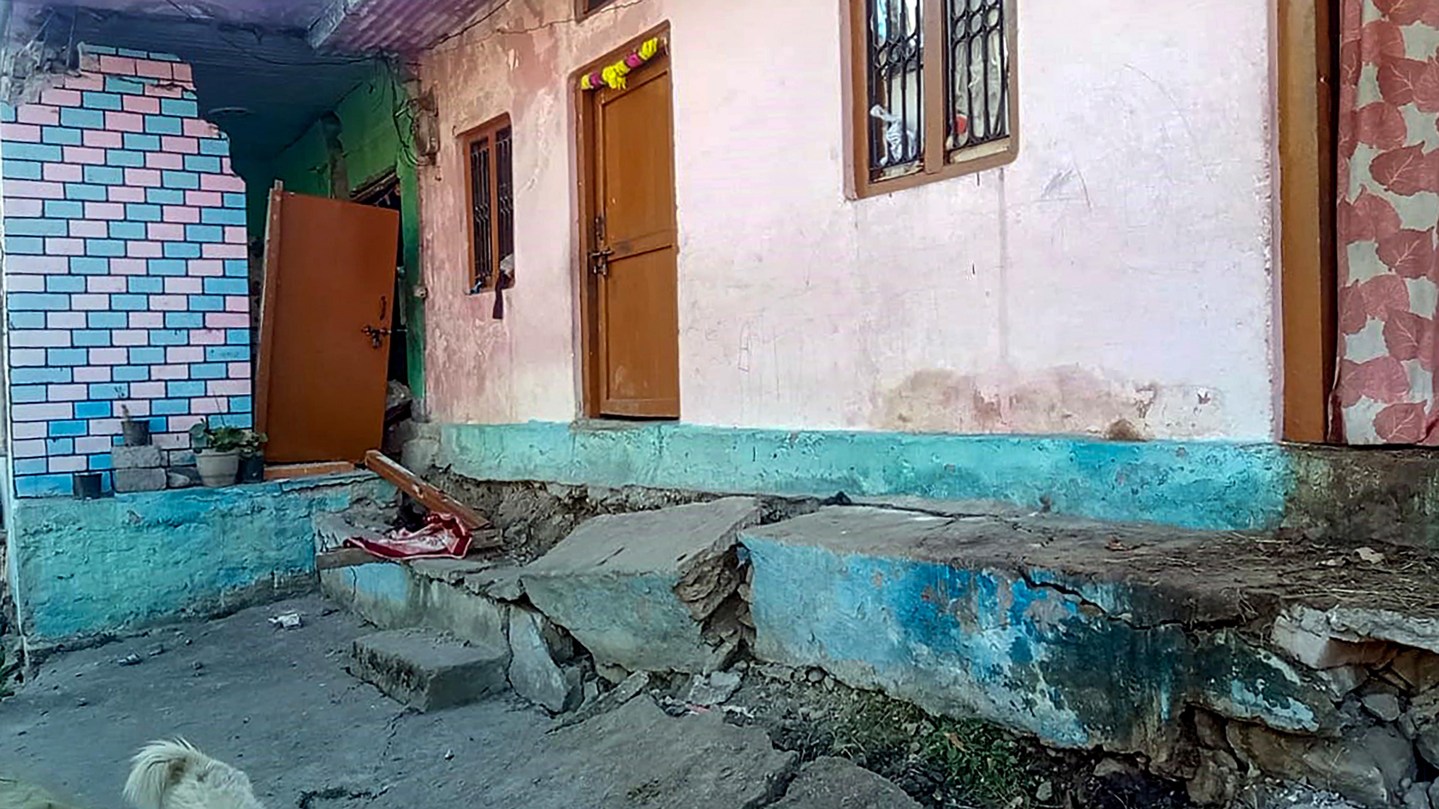 Cracks appear at a house by the gradual sinking of Joshimath in Chamoli district. Credit: PTI Photo