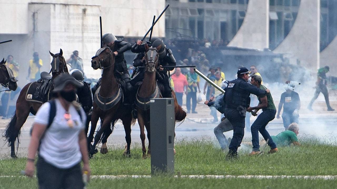 Supporters of Brazilian former President Jair Bolsonaro clash with security forces during an invasion to Planalto Presidential Palace in Brasilia on January 8. Credit: AFP Photo