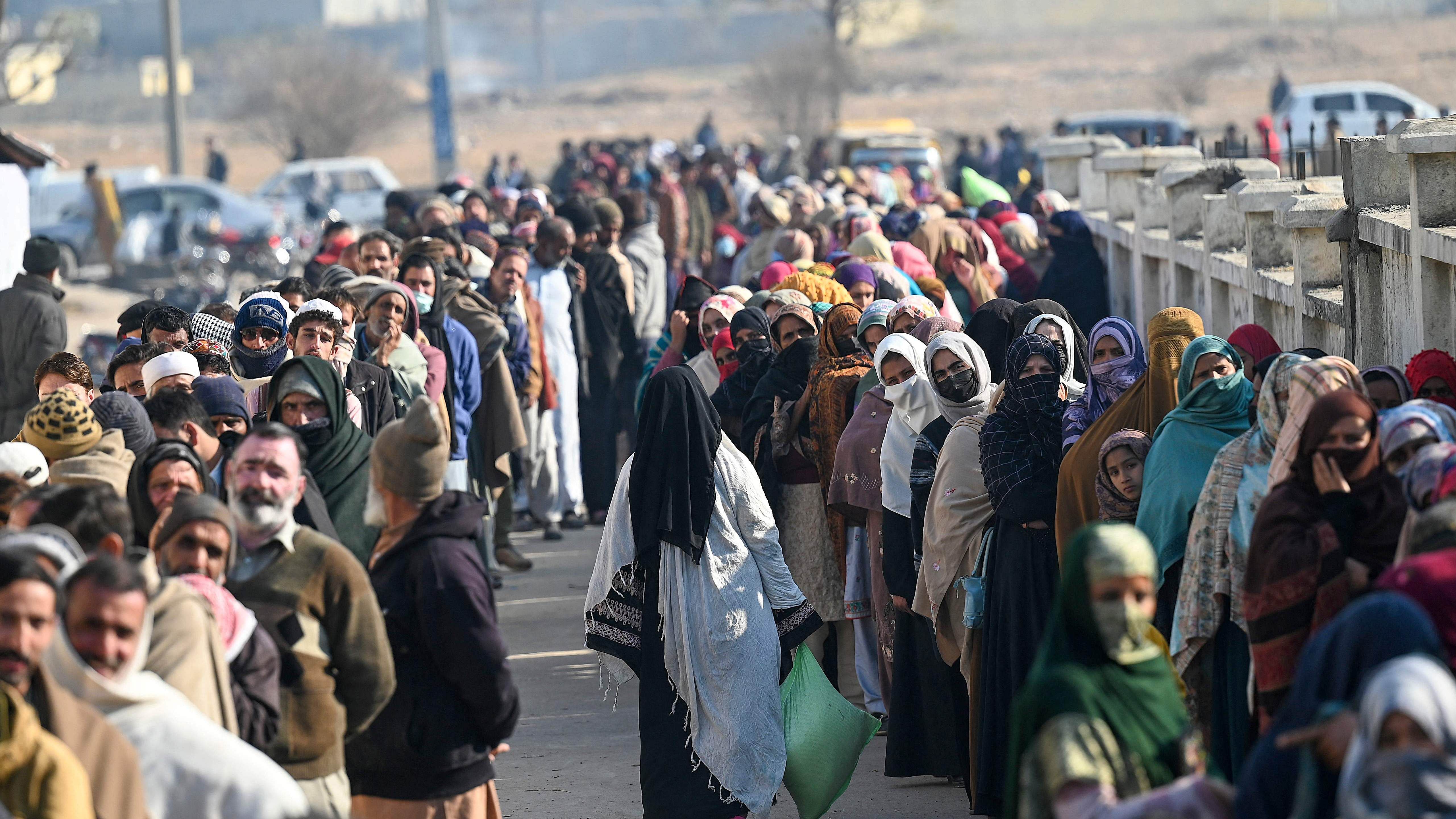 Local residents queue to buy wheat flour at government-controlled prices in Islamabad on January 10, 2023. Credit: AFP File Photo