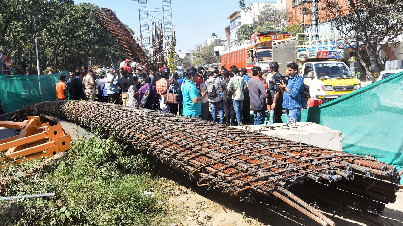 People gather at the accident site where a half broken iron structure of a metro pillar fell, at Hennur Main Road in Bengaluru, Tuesday, Jan. 10, 2023. Credit: PTI Photo