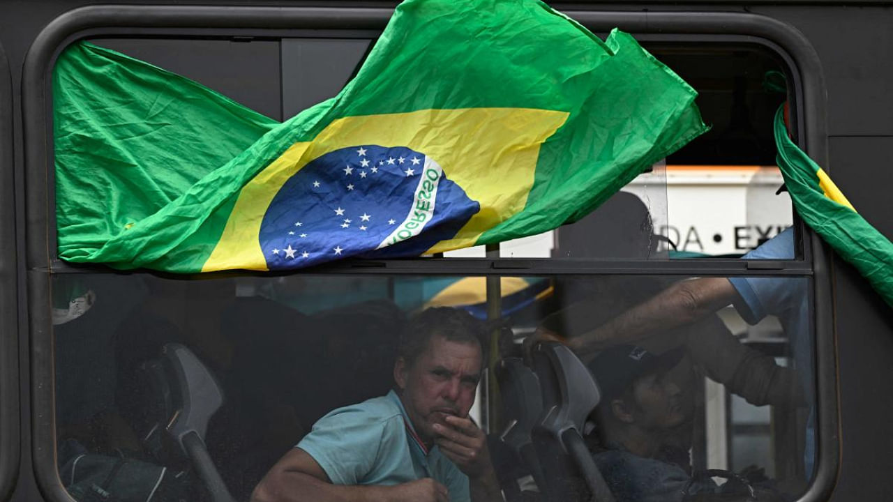 Supporters of Brazil's far-right ex-president Jair Bolsonaro in custody. Credit: AFP Photo