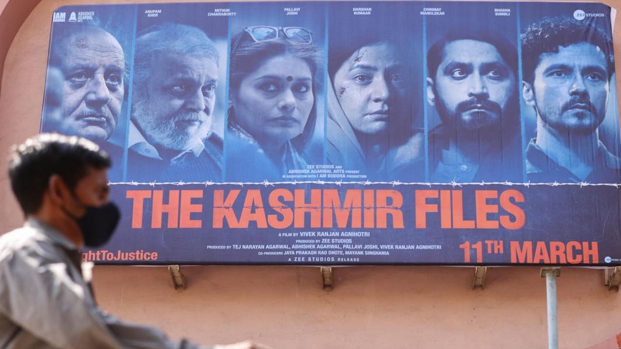 A man walks past a poster of Bollywood movie 'The Kashmir Files'. Credit: PTI photo