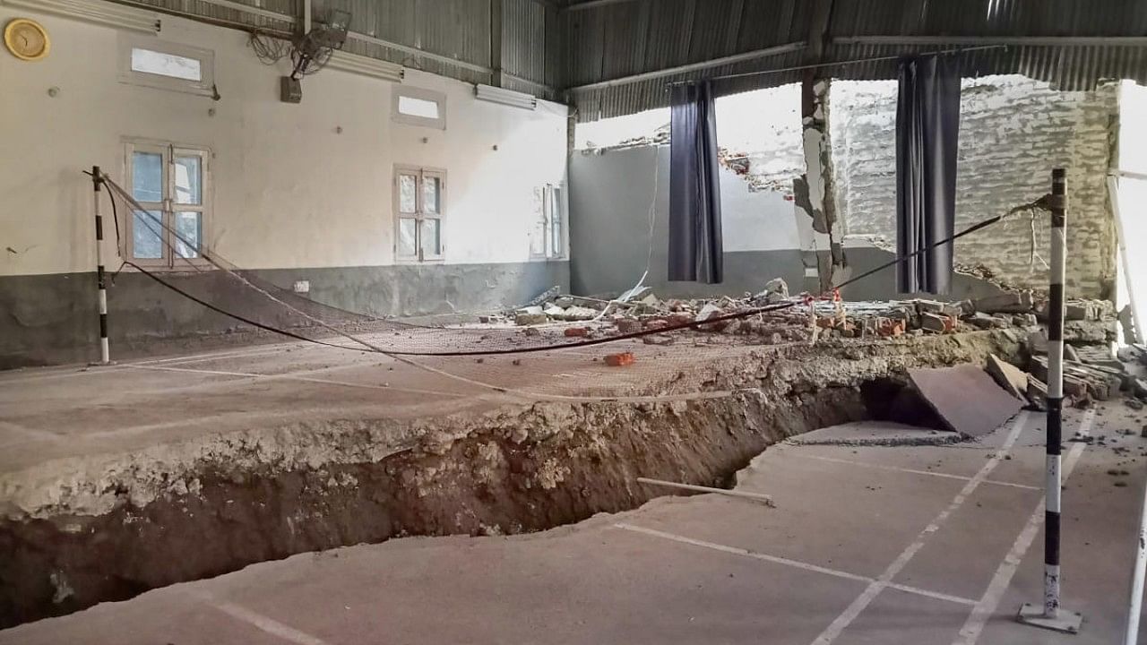 Cracks appear at an indoor badminton court in Joshimath area of Chamoli district. Credit: PTI Photo