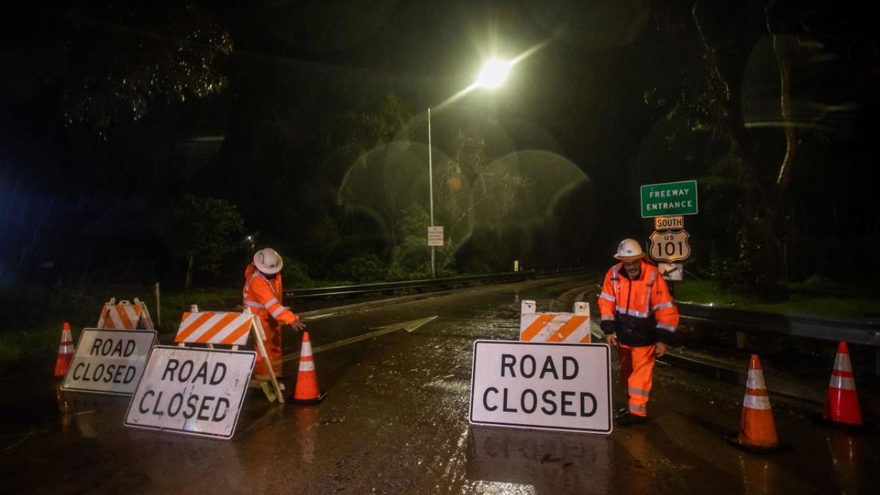 Road workers close the access to the 101 Freeway at Olive Mill Road as a result of San Ysidro Creek overflowing due to heavy rainfall in the area. Credit: AFP Photo