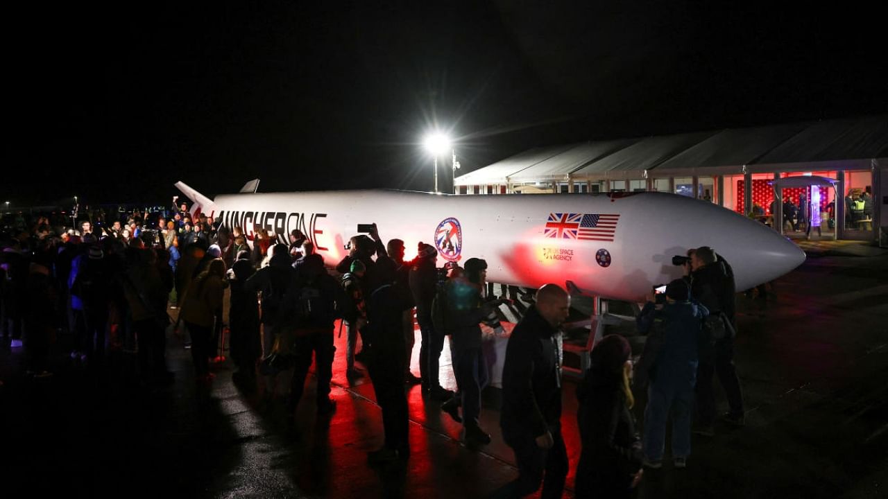 Spectators gather around a replica rocket at Cornwall Airport Newquay to watch the first ever UK launch of Virgin Orbit's LauncherOne rocket from Spaceport Cornwall in Newquay, Britain, January 9, 2023. Credit: Reuters Photo