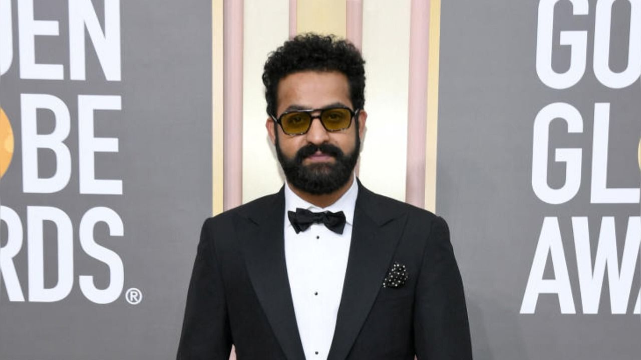 NTR Jr poses for shutterbugs at the red carpet of Golden Globes. Credit: Reuters Photo