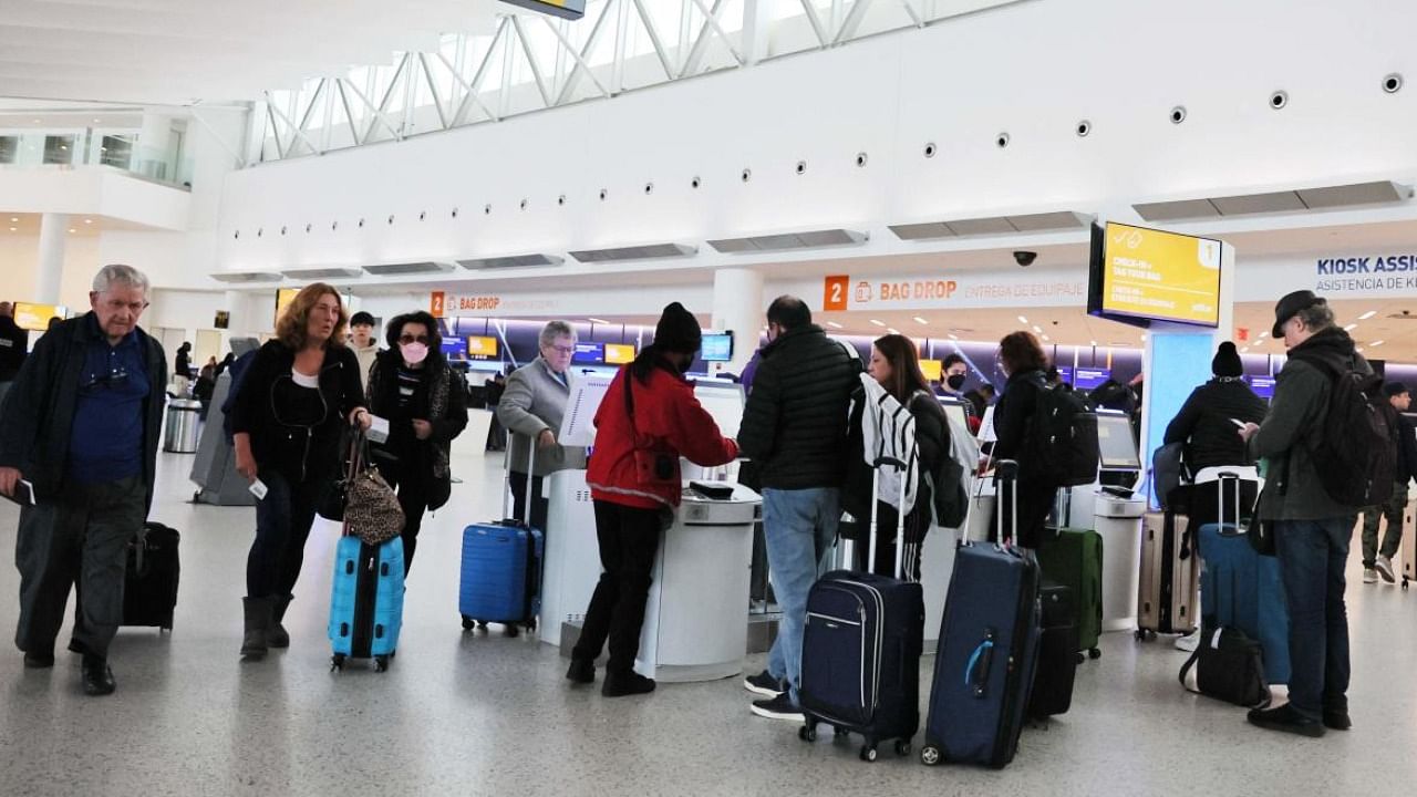 People check-in for their flight at JFK airport in New York City. Credit: AFP Photo