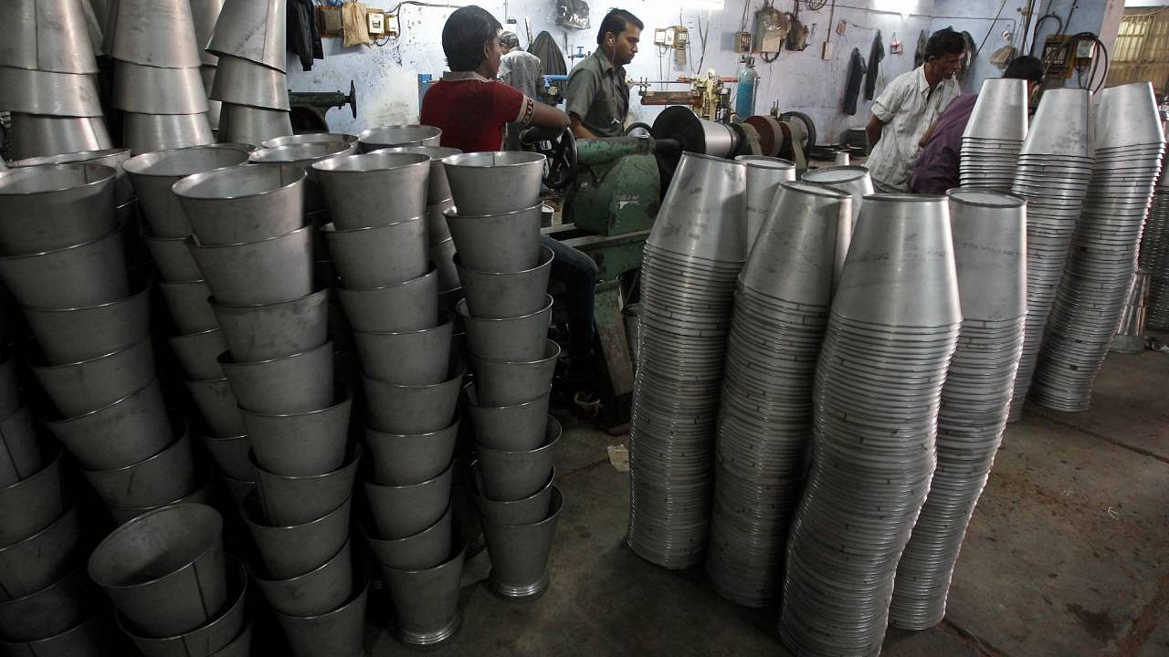 Employees work inside a steel bucket manufacturing unit at an industrial area on the outskirts of Ahmedabad. Credit: Reuters Photo