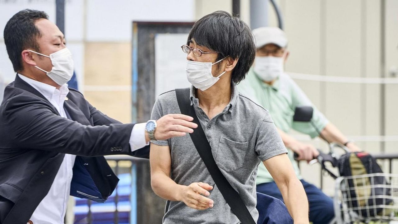 Tetsuya Yamagami (centre) is detained near the site of gunshots in Nara, western Japan Friday, July 8, 2022. Credit: AP/PTI Photo