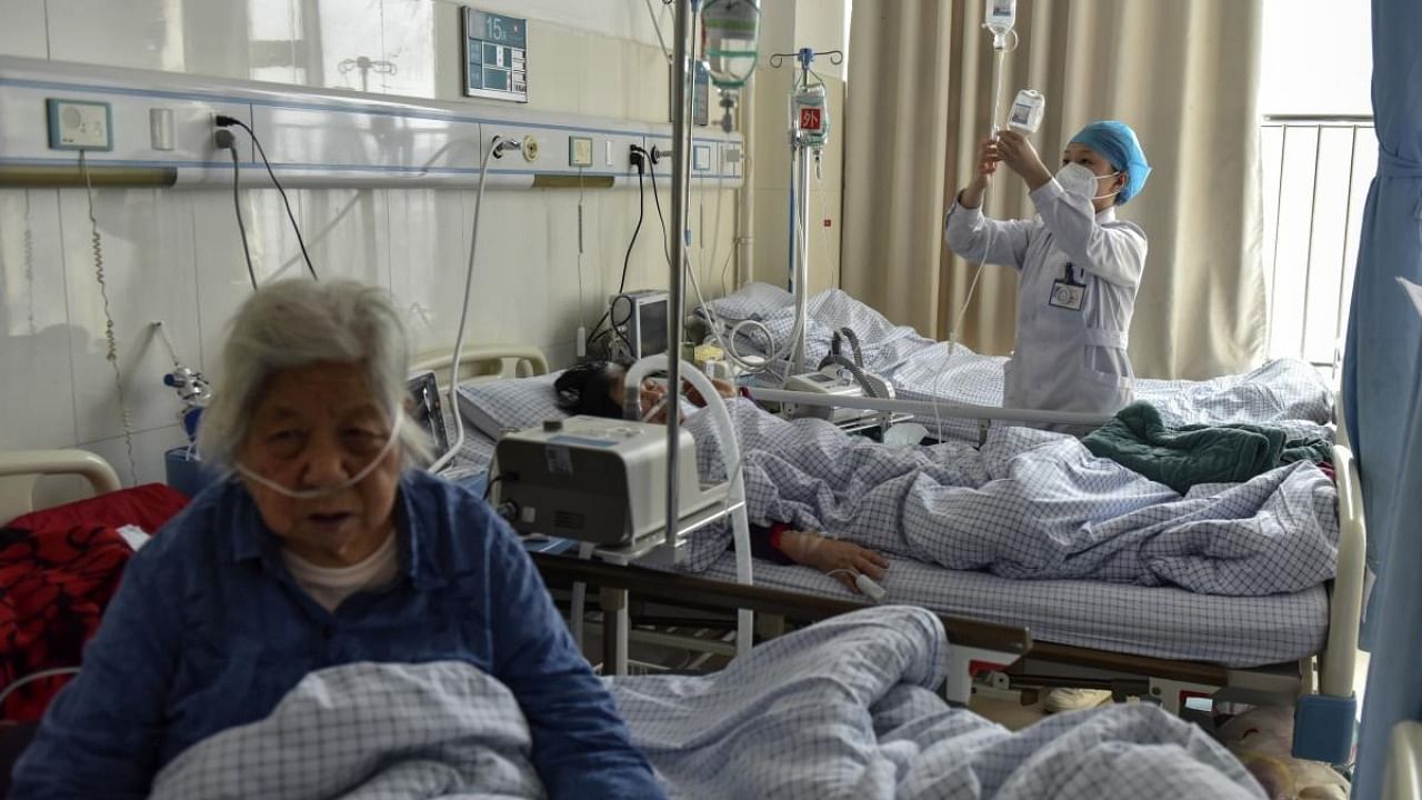 Elderly patients with Covid symptoms receive intravenous drips at the emergency ward of a hospital in Fuyang in central China's Anhui province. Credit: AP/PTI Photo