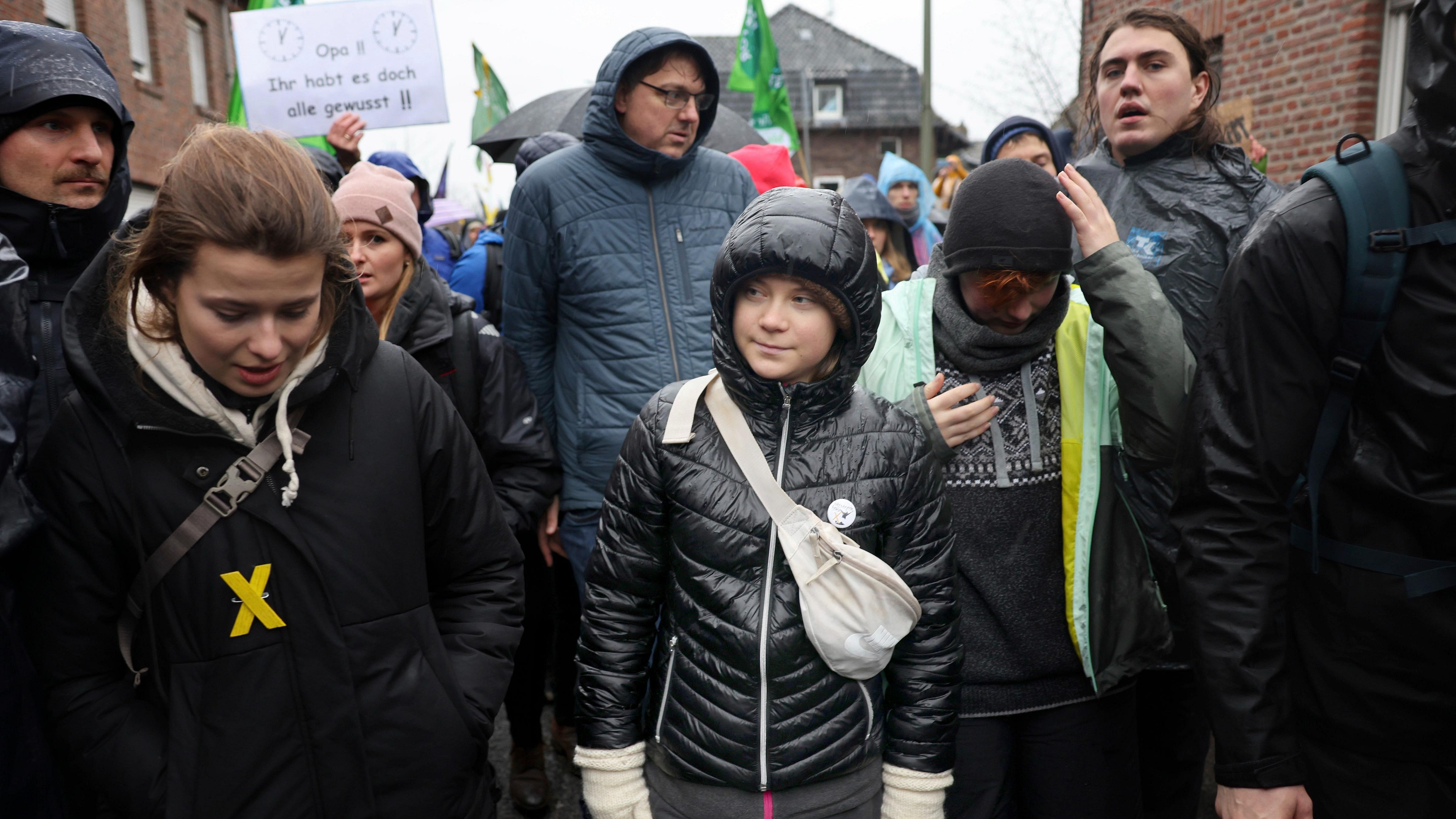 Climate activists Luisa Neubauer, left, and Greta Thunberg, center, march together during a protest. Credit: AP Photo