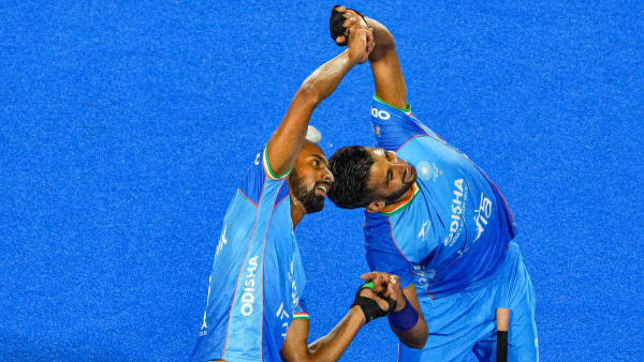 Hardik Singh (8) of India with teammate Manpreet Singh (7) celebrates after scoring a goal against Spain during a match of FIH Odisha Hockey Men's World Cup 2023. Credit: PTI Photo