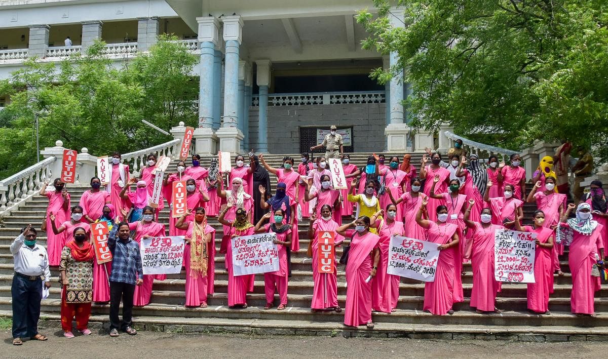 A file photo of Asha workers staging a protest, urging the government to hike their honorarium. Credit: DH Photo