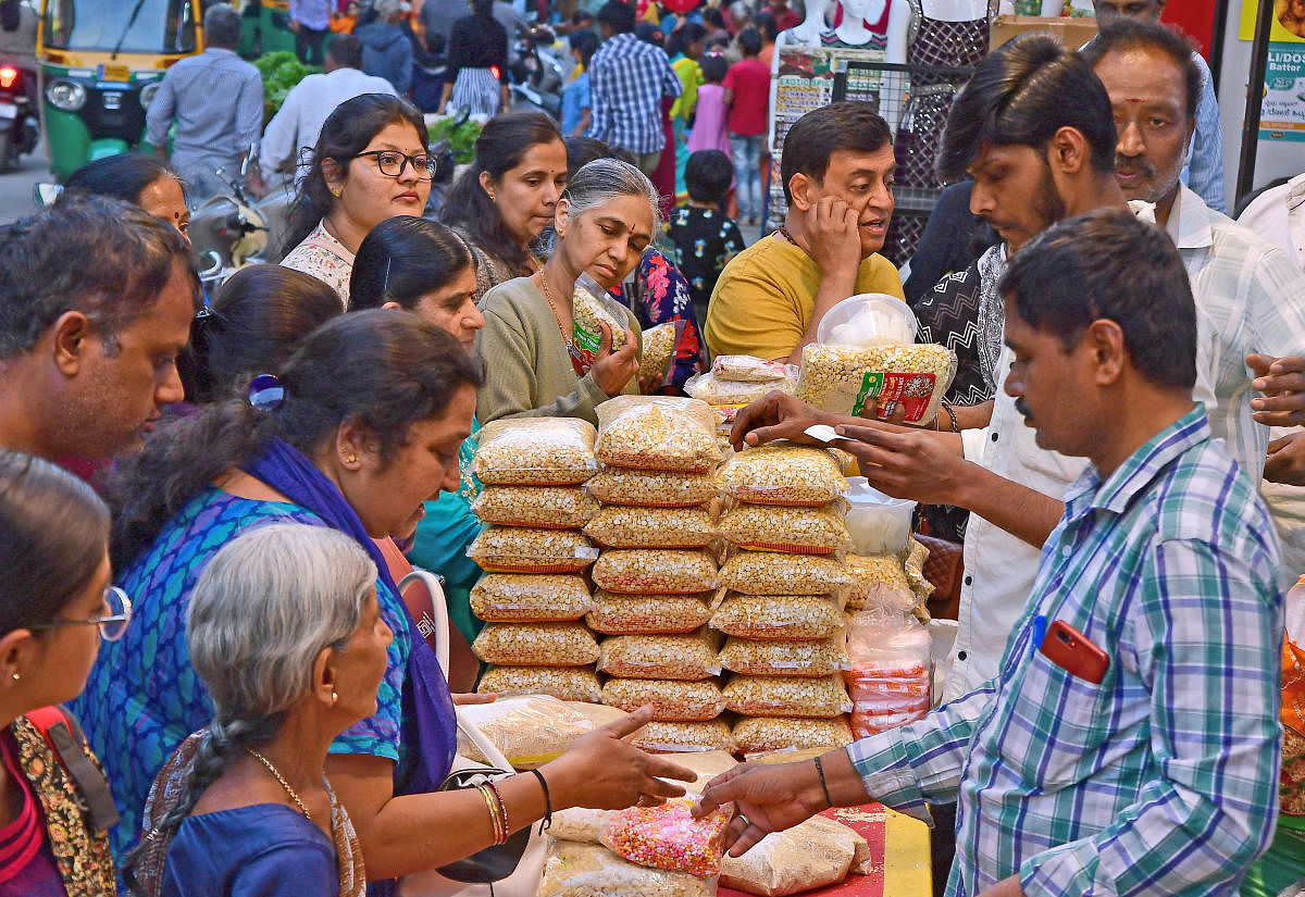 Vendors of Ellu Bella make a brisk business in Gandhi Bazaar, on the eve of Sankranthi on Saturday. Credit: DH Photo/Ranju P