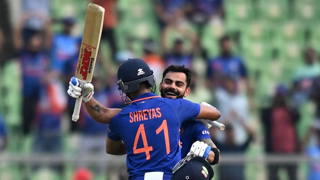 Virat Kohli (R) is congratulated by his teammate Shreyas Iyer after he scored a century (100 runs) during the third and final ODI against Sri Lanka. Credit: AFP Photo