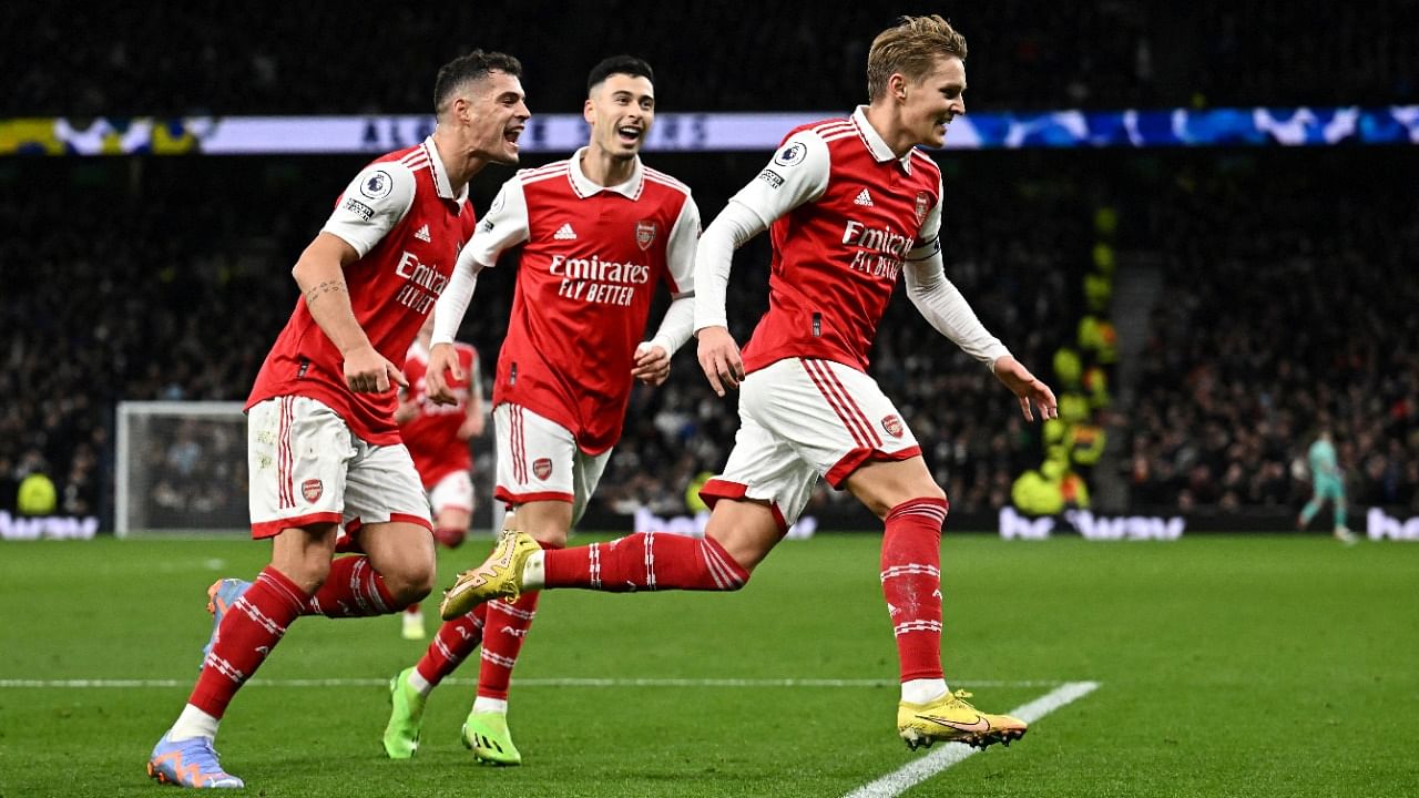 Arsenal's Martin Odegaard celebrates scoring their second goal with Granit Xhaka and Gabriel Martinelli. Credit: Reuters Photo