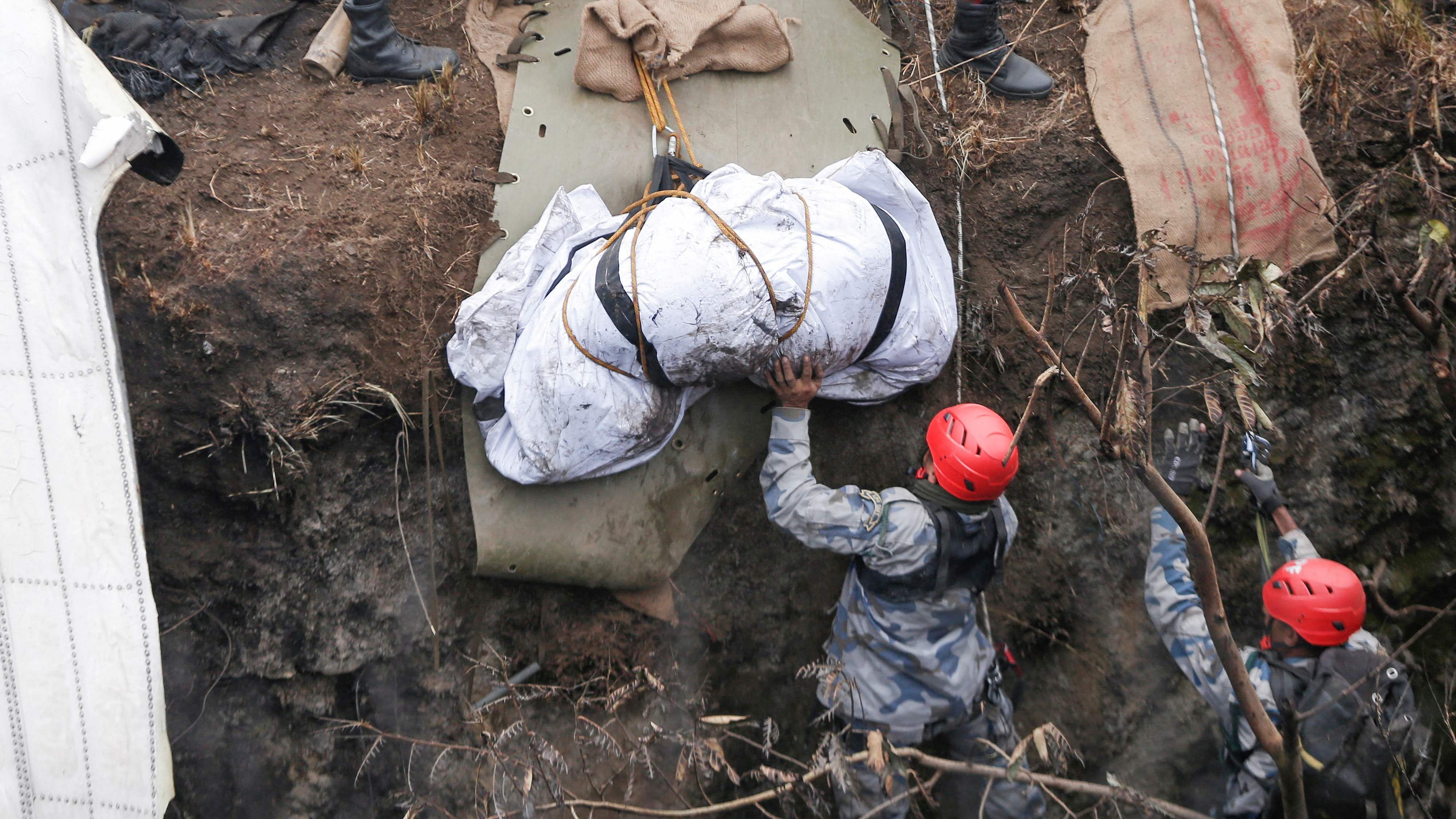 A rescue team recovers the body of a victim from the site of the plane crash of a Yeti Airlines operated aircraft, in Pokhara, Nepal January 16, 2023. Credit: Reuters Photo