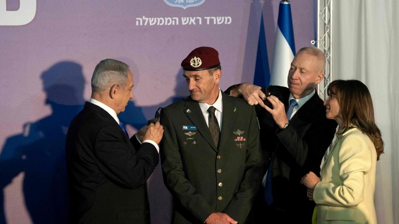Israeli Prime Minister Benjamin Netanyahu (L) and Defence Minister Yoav Gallant (2nd R) promote the new army chief of staff Herzi Halevi to the rank of Lieutenant-General, during his official appointment ceremony attended by his wife Sharon (R) in Jerusalem, on January 16, 2023. Credit: AFP Photo