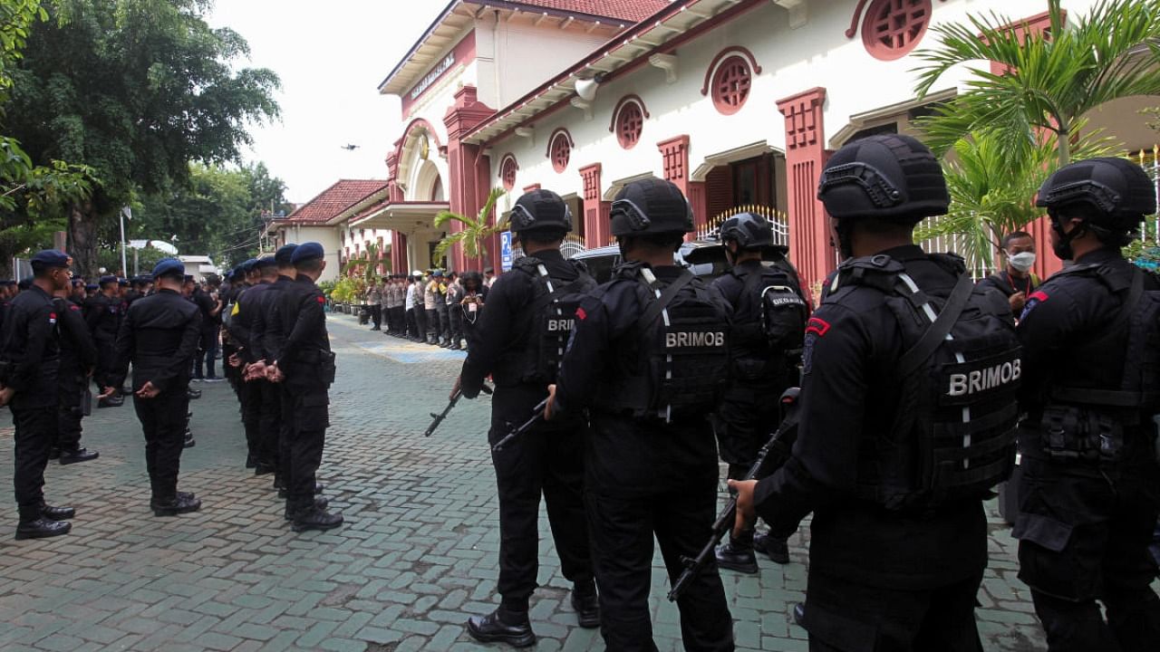 Mobile brigade police personnel take part in a briefing ceremony at the Surabaya court ahead of the first trial over a soccer stampede in East Java. Credit: AFP Photo