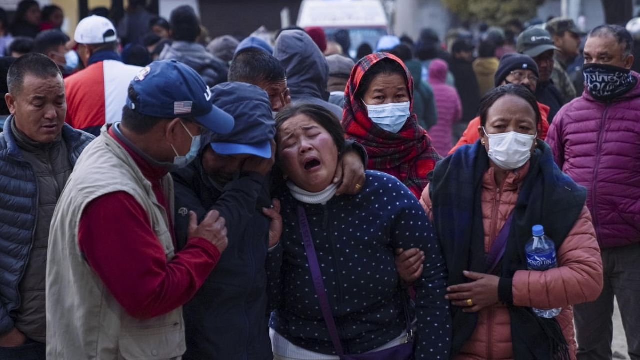 A woman cries as the body of a relative, victim of the plane crash, is brought to a hospital in Pokhara. Credit: AP/PTI Photo