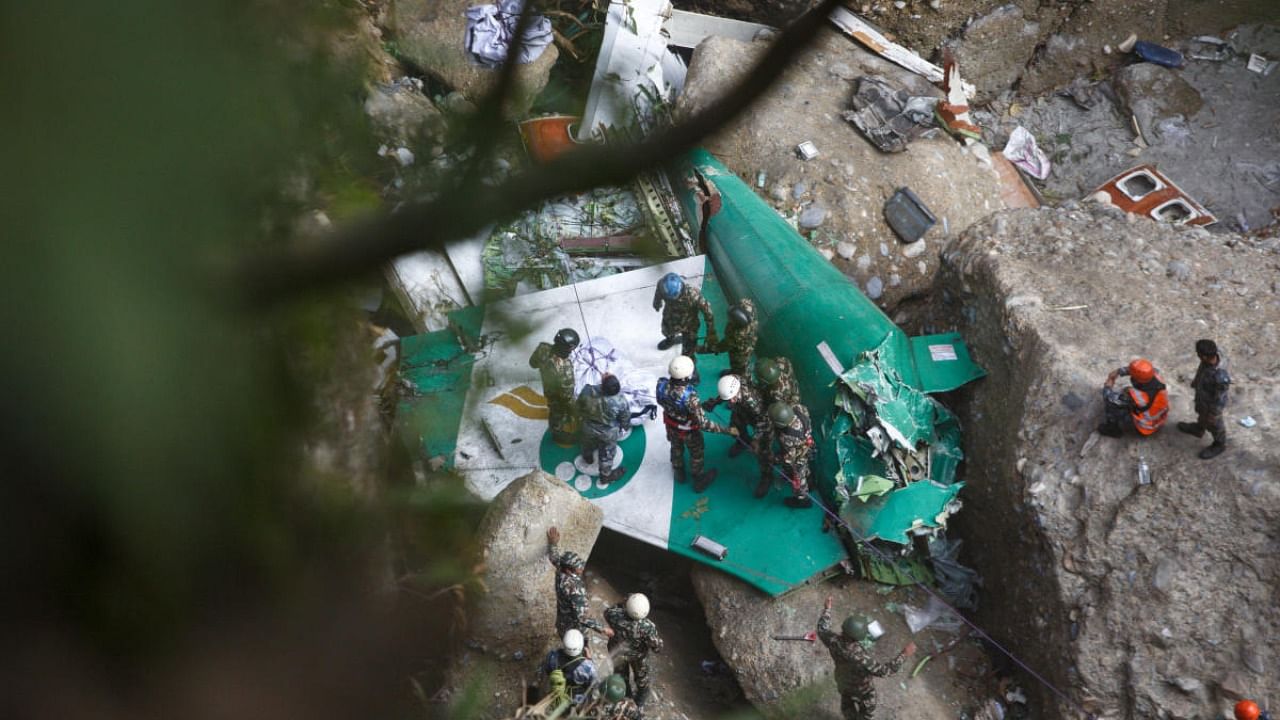 A rescue team recovers the body of a victim from the site of the plane crash of a Yeti Airlines operated aircraft, in Pokhara, Nepal January 16, 2023. Credit: Reuters Photo