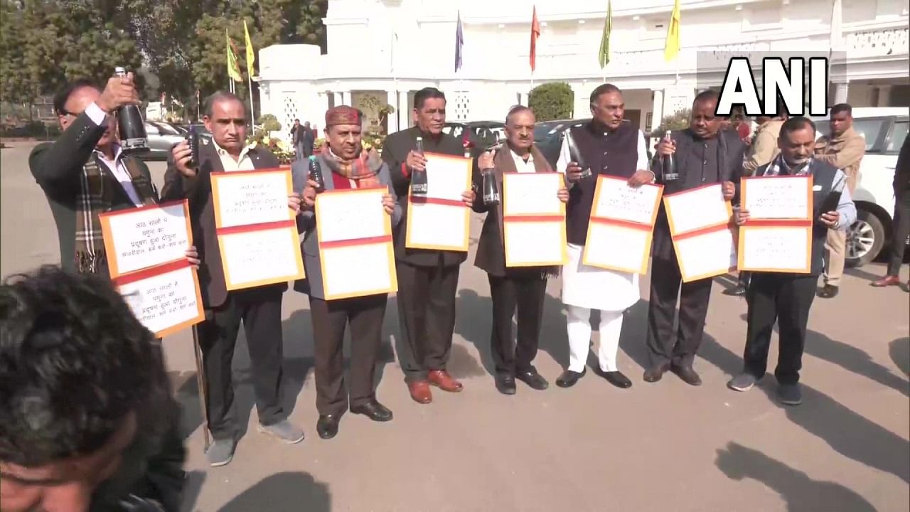 BJP MLAs hold bottles of polluted water from the Yamuna in protest against the river's pollution. Credit: Twitter/@ANI