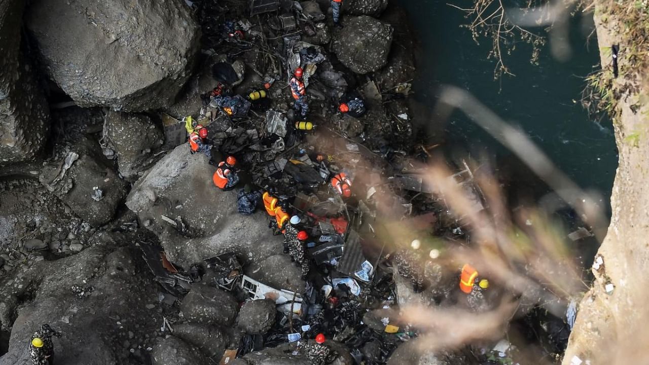 Rescue teams search for victims at the site of the Yeti Airlines plane crash, in Pokhara. Credit: AFP Photo