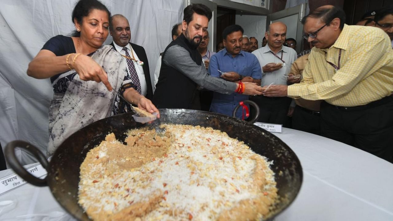 Union Minister for Finance Nirmala Sitharaman and MoS Anurag Thakur distribute halwa to officials during the 'Halwa Ceremony' to mark the beginning of printing of budgetary documents. Credit: PTI File Photo