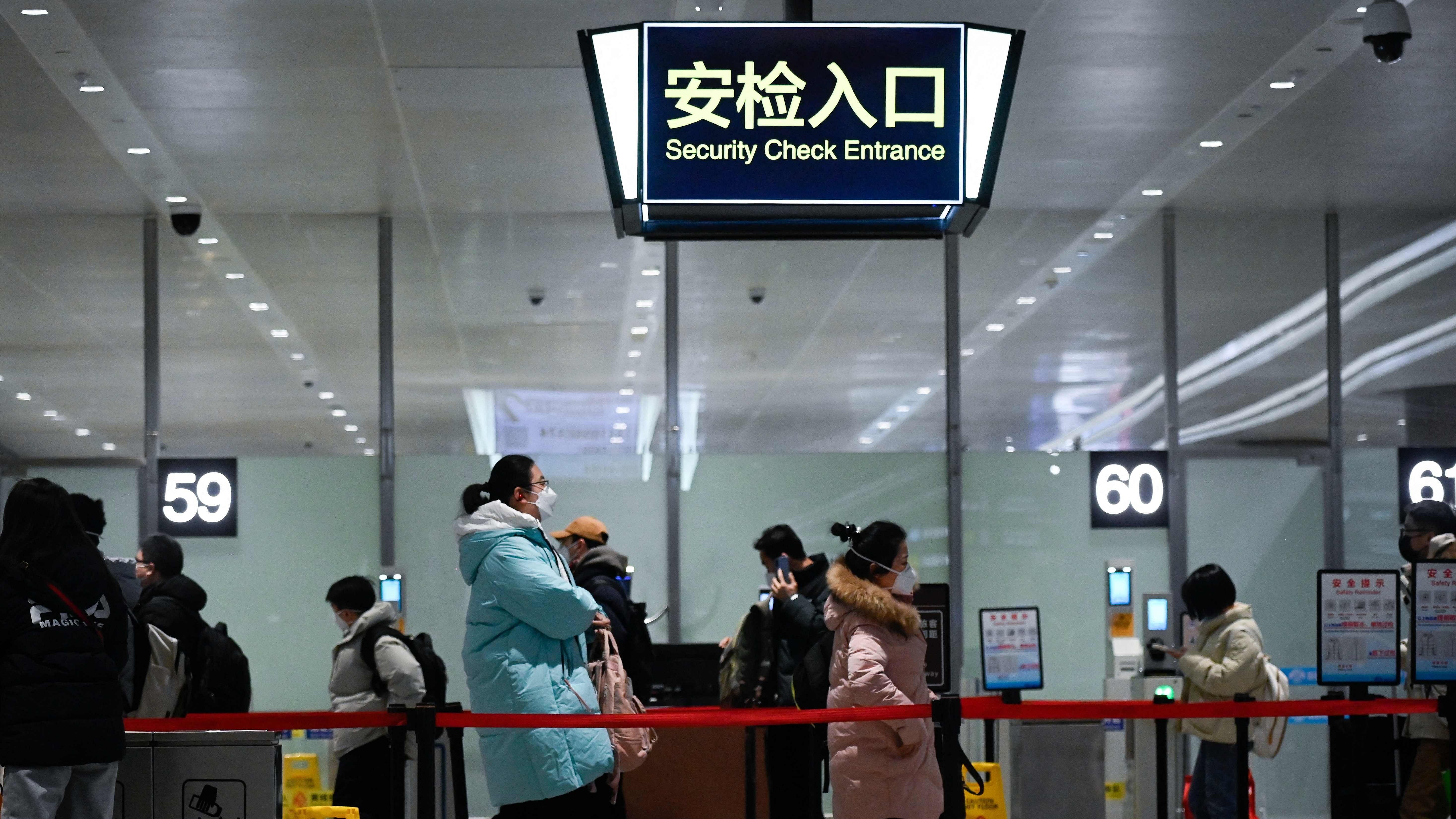 Passengers walk towards the entrance of the security check at Daxing International airport in Beijing. Credit: AFP Photo