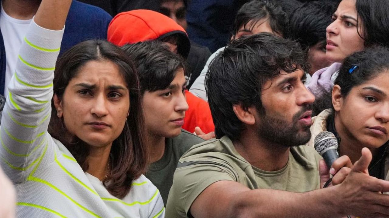 Wrestlers Vinesh Phogat, Bajrang Punia and Sakshi Malik address a press conference after a meeting with officials of Union Sports Ministry regarding their protest against the Wrestling Federation of India (WFI), in New Delhi, Thursday, Jan. 19, 2023. Credit: PTI Photo