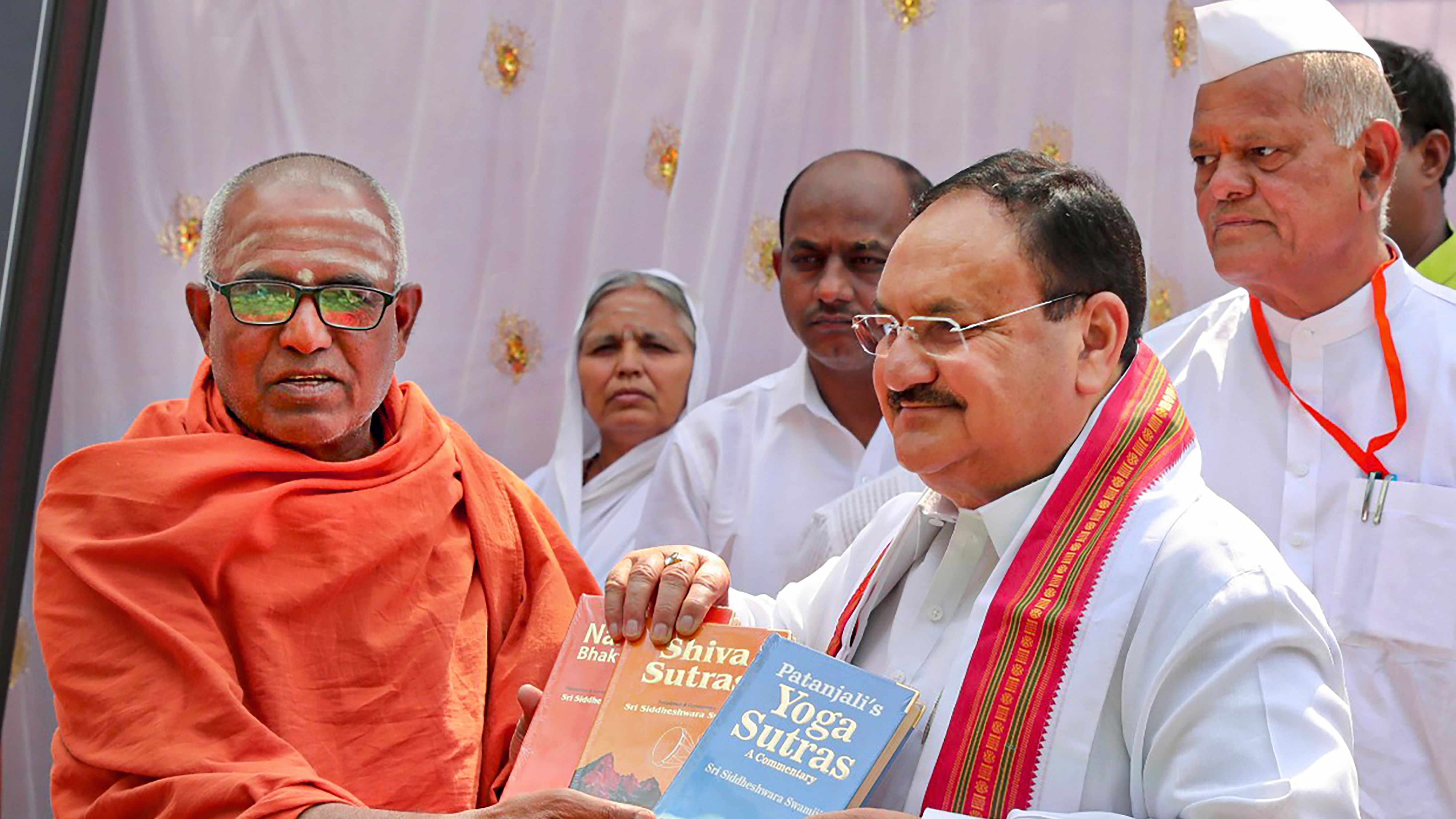 BJP national president J P Nadda flew down to Vijayapura in north Karnataka bordering Maharashtra and went to the Jnanayogashrama to pay his obeisance to Sri Siddheshwar Swamiji, who passed away recently. Credit: PTI Photo