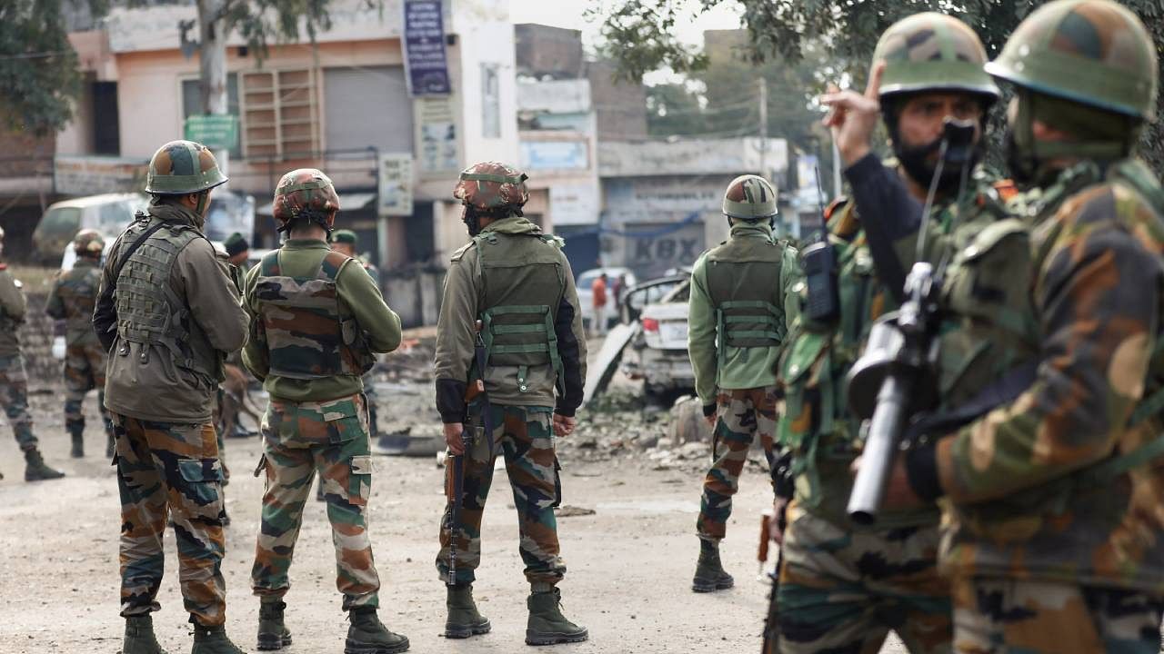 Security personnel stand guard after two blasts occurred at Narwal area in Jammu. Credit: PTI Photo