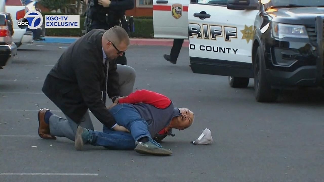 A suspect is arrested by law enforcement personnel after a mass shooting at two locations in the coastal northern California city of Half Moon Bay. Credit: KGO via Reuters