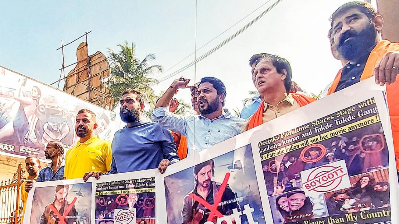 VHP members raise slogans during a protest against the release of Shah Rukh Khan's film 'Pathaan', in Bengaluru. Credit: PTI 