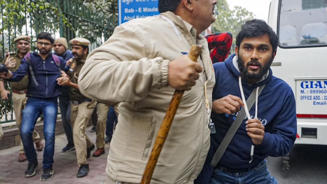 Delhi Police personnel detain students after Students' Federation of India (SFI)'s announcement to screen the BBC documentary on Prime Minister Narendra Modi, at the Jamia Millia Islamia campus. Credit: PTI Photo