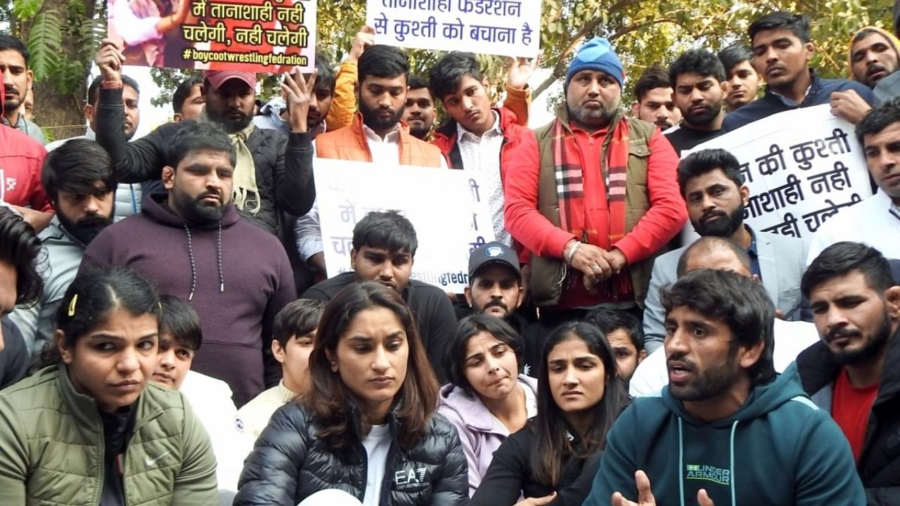 Indian wrestlers Sakshee Malikkh, Vinesh Phogat and Bajrang Punia with others addressing the media during their protest against the Wrestling Federation of India (WFI) president Brij Bhushan, at Jantar Mantar in New Delhi on Wednesday, Jan. 18, 2023. Credit: IANS Photo