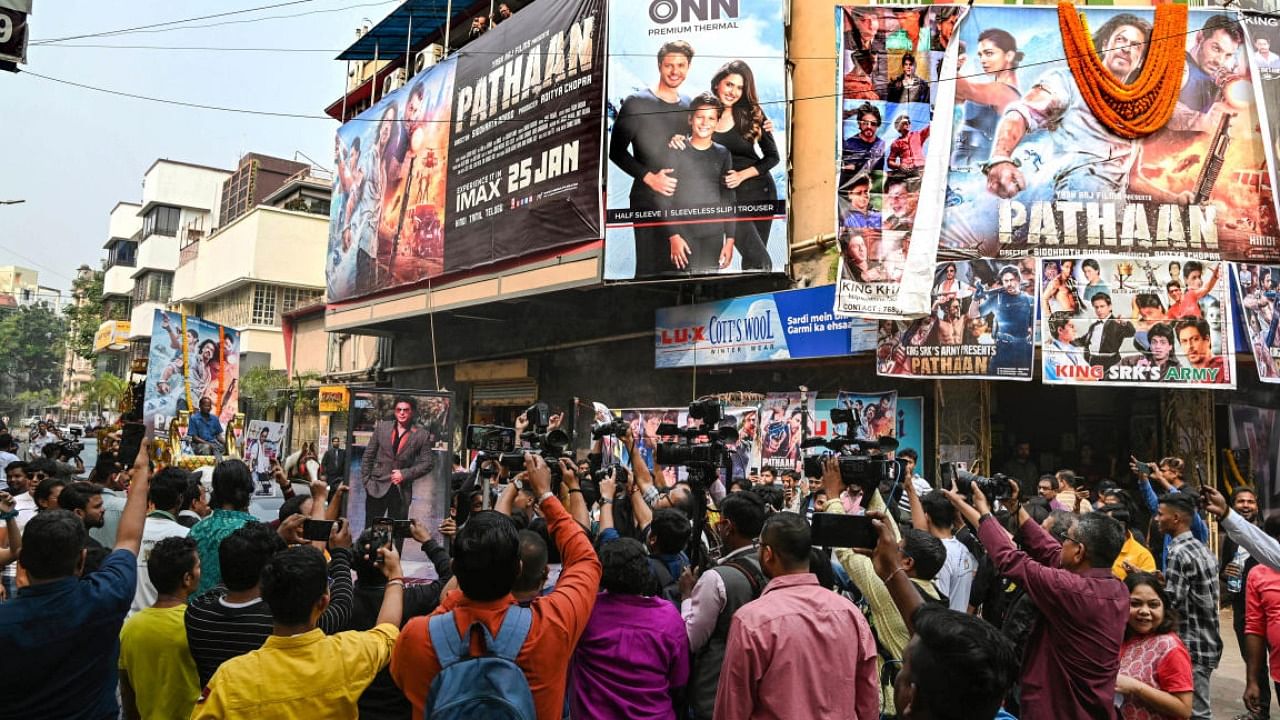 Fans of Bollywood megastar Shah Rukh Khan gather outside a movie theatre to celebrate the release of his movie 'Pathaan', in Kolkata. credit: PTI 