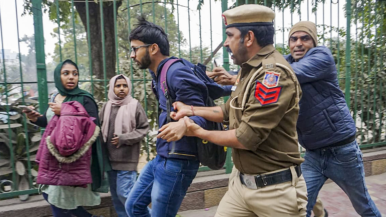 Delhi Police personnel detain a student after SFI's announcement to screen the BBC documentary on PM Narendra Modi at the Jamia Millia Islamia campus in New Delhi. Credit: PTI Photo