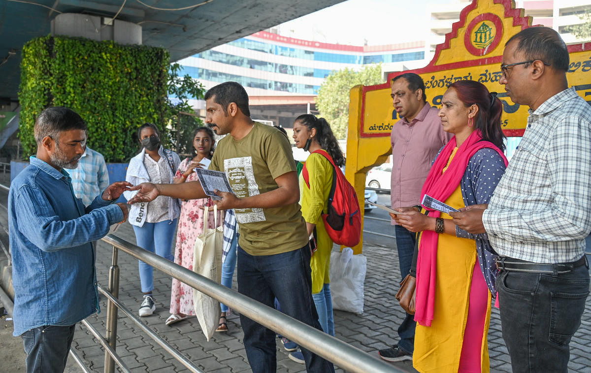 Patent consultant Vinay Kumar (in T-shirt) distributed the postcards (right) near the Constitution Circle in Yeshwanthpur as part of a Preamble reading event on Republic Day. DH PHOTO BY S K DINESH