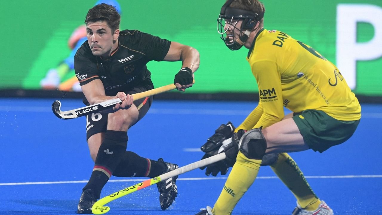 Germany's Gonzalo Peillat (L) fights for the ball during the men's semi-final match between Australia and Germany at the FIH Odisha Field Hockey Men's World Cup 2023, in Bhubaneswar on January 27, 2023. Credit: AFP Photo