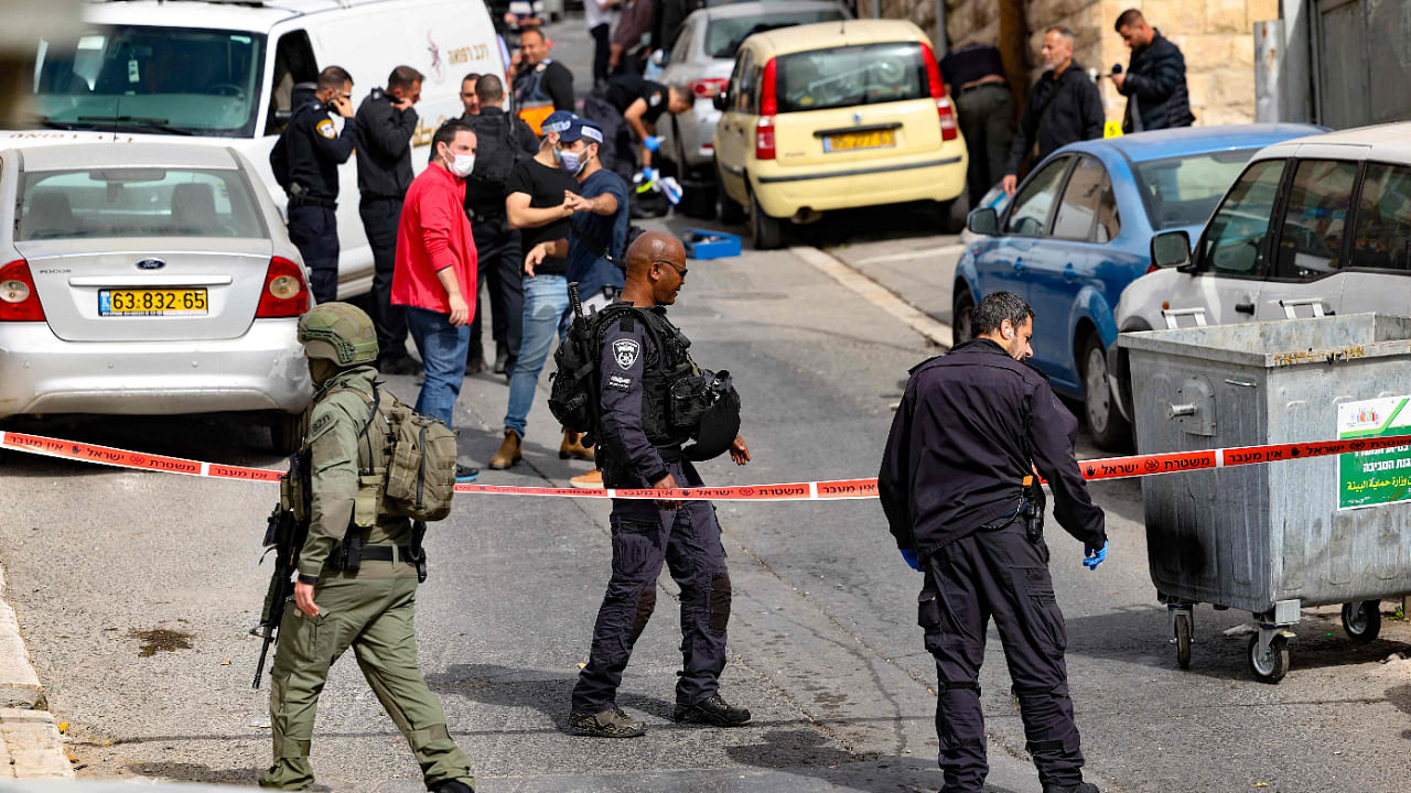 Israeli security forces and emergency service personnel gather at a cordoned-off area in Jerusalem's predominantly Arab neighbourhood of Silwan, where an assailant reportedly shot and wounded two people, on January 28. Credit: AFP Photo