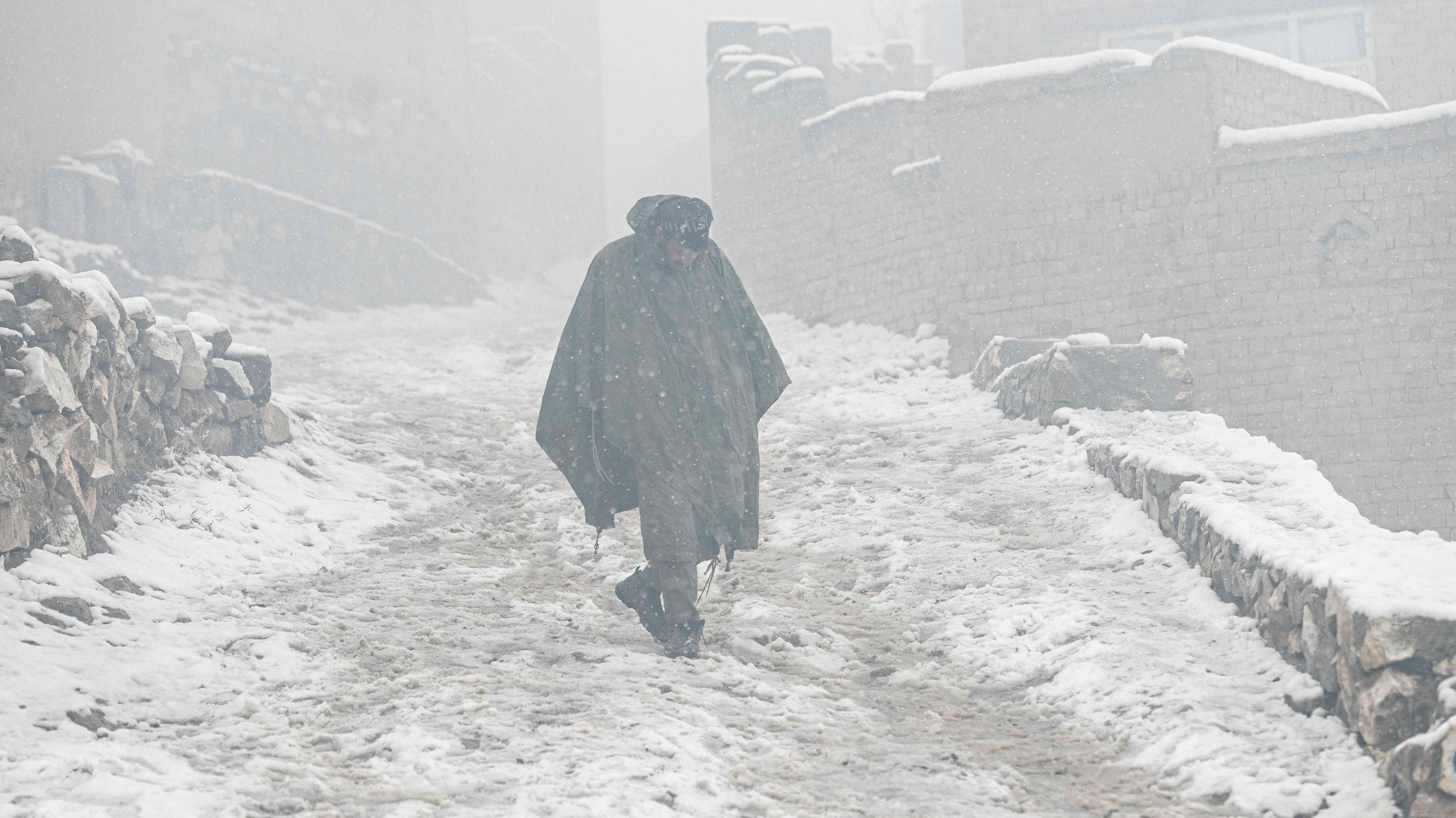 In this file photo taken on January 8, 2023, an Afghan man walks down a street during snowfall in Kabul. Credit: AFP Photo