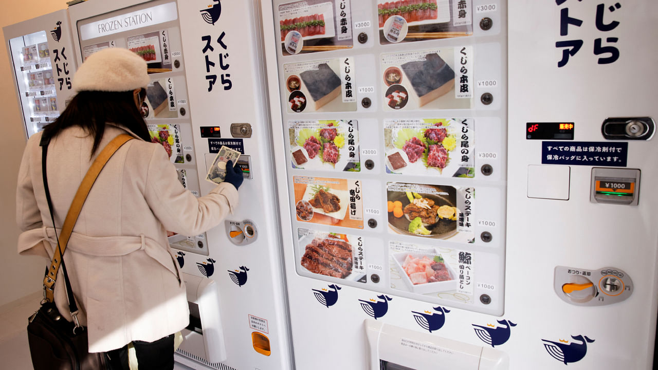 A customer buys whale meat on the opening day of the shop by a Japanese whale-hunting company with vending machines, in Yokohama, Japan. Credit: Reuters Photo